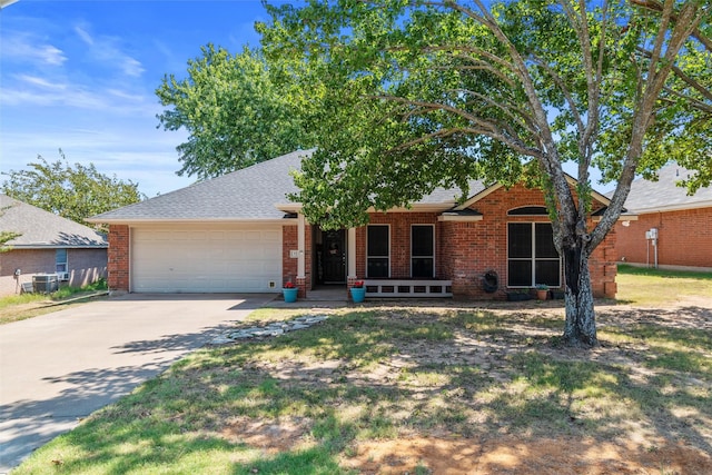 ranch-style home featuring central AC and a garage