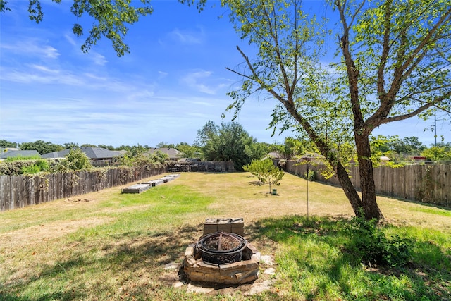 view of yard with an outdoor fire pit