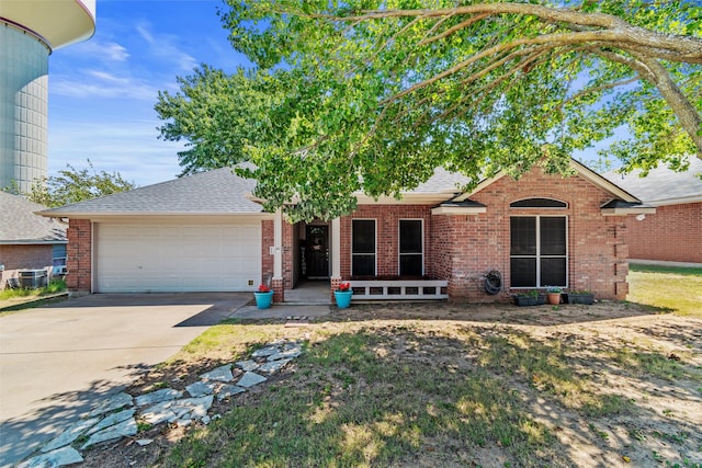 single story home featuring central AC and a garage