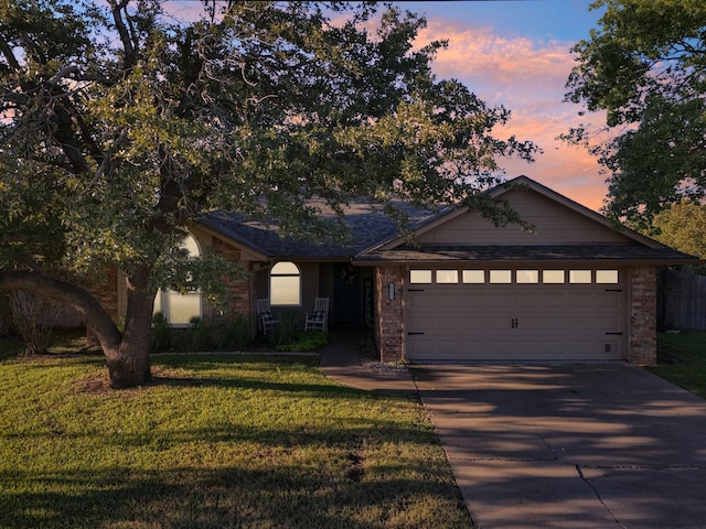 view of front facade featuring a yard and a garage