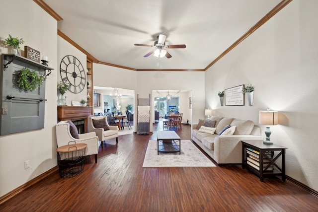 living room featuring ceiling fan with notable chandelier, crown molding, and dark wood-type flooring