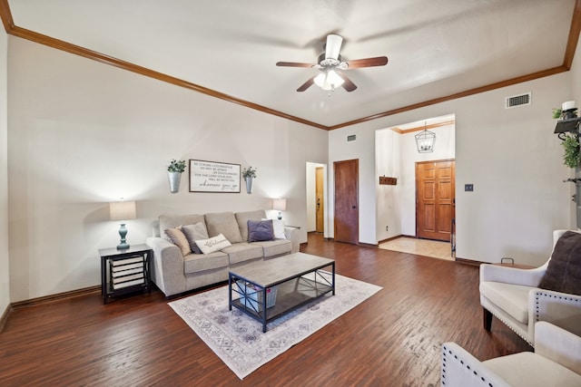 living room featuring dark hardwood / wood-style floors, ceiling fan, and crown molding