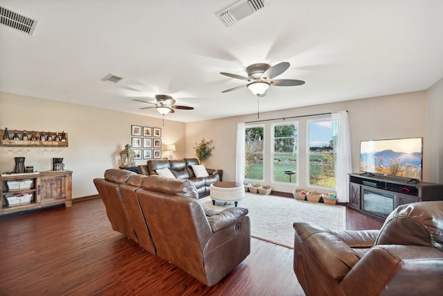 living room featuring dark hardwood / wood-style floors and ceiling fan