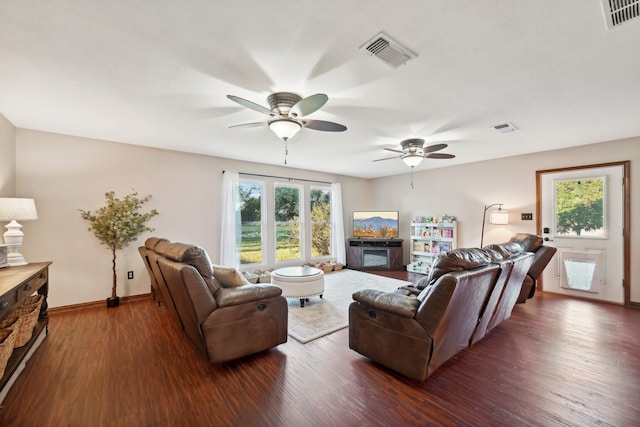 living room featuring dark hardwood / wood-style flooring, plenty of natural light, and ceiling fan