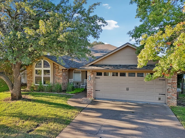 view of front of house with a garage and a front lawn