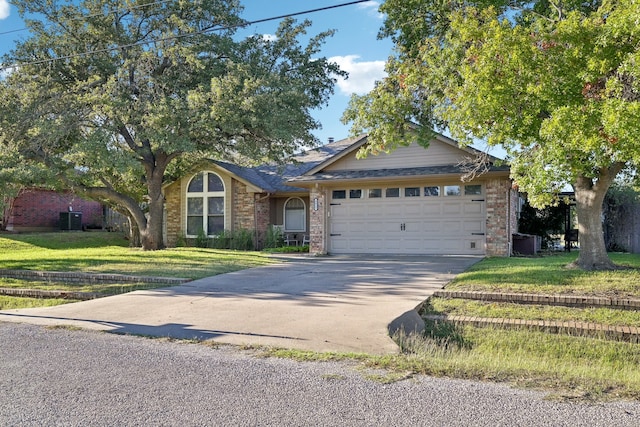 view of front of house with a garage, a front lawn, and cooling unit