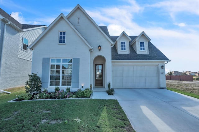 view of front of property with a garage and a front yard