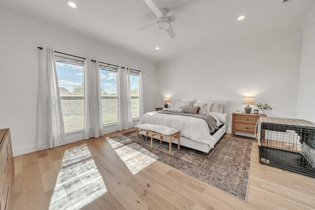 bedroom with ceiling fan, light hardwood / wood-style flooring, and crown molding