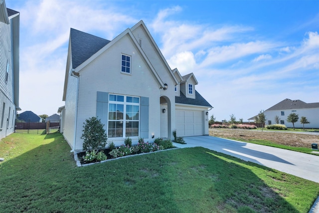 front of property featuring a front yard and a garage