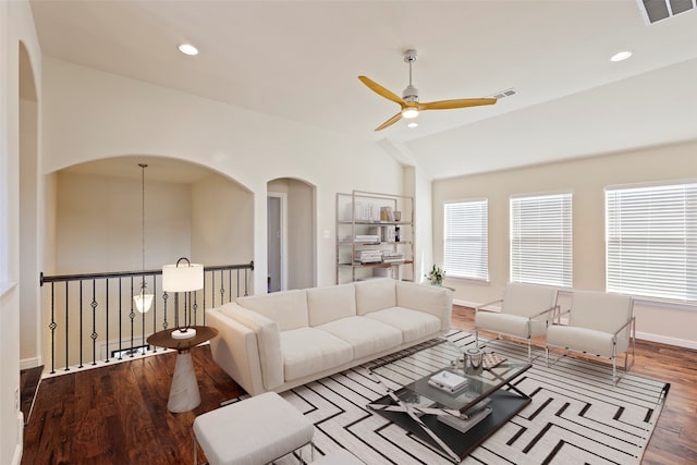 living room with hardwood / wood-style flooring, ceiling fan, and lofted ceiling