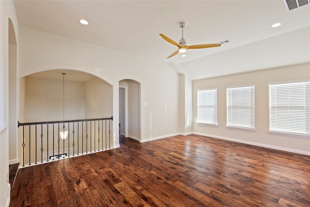 unfurnished room featuring ceiling fan, dark wood-type flooring, and vaulted ceiling