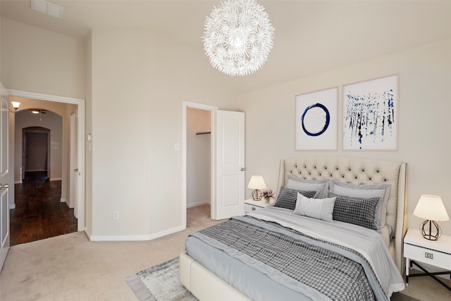 bedroom featuring carpet flooring and a chandelier