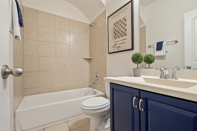 full bathroom with tile patterned flooring, vanity, tiled shower / bath combo, and toilet