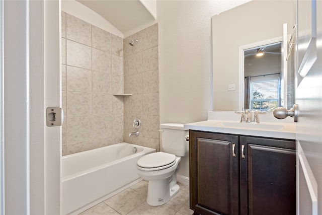 full bathroom featuring tile patterned floors, tiled shower / bath combo, toilet, and vanity