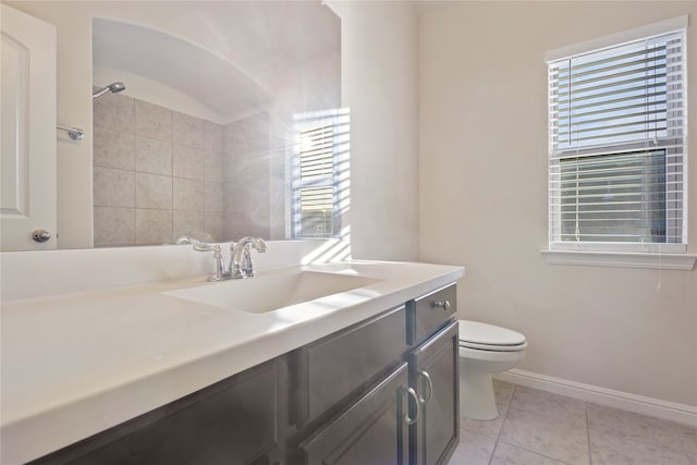 bathroom with tile patterned flooring, vanity, and toilet