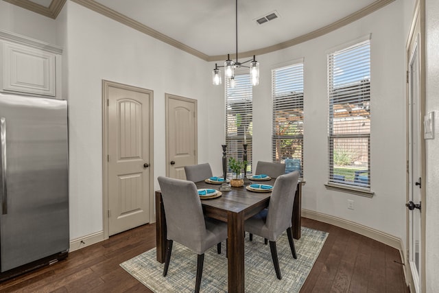 dining area featuring ornamental molding and dark wood-type flooring