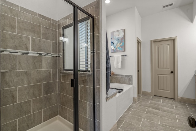 bathroom with separate shower and tub