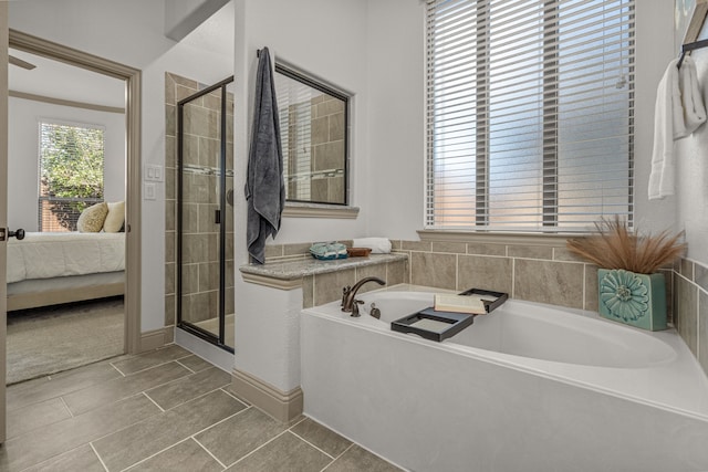 bathroom with tile patterned floors and shower with separate bathtub