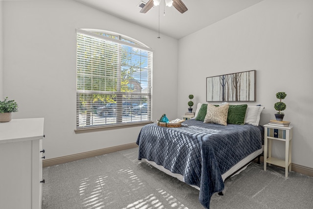 carpeted bedroom with multiple windows and ceiling fan