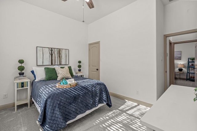 bedroom with ceiling fan, a towering ceiling, and carpet floors