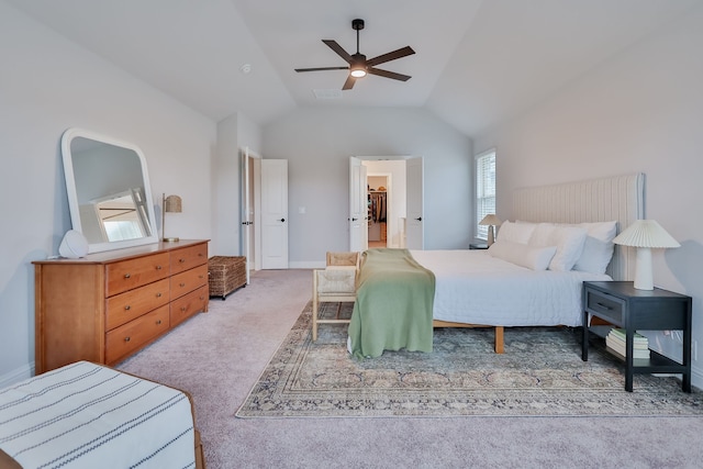 carpeted bedroom with multiple windows, ceiling fan, and vaulted ceiling