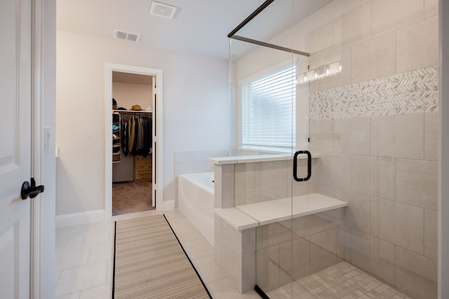 bathroom featuring tile patterned floors and separate shower and tub