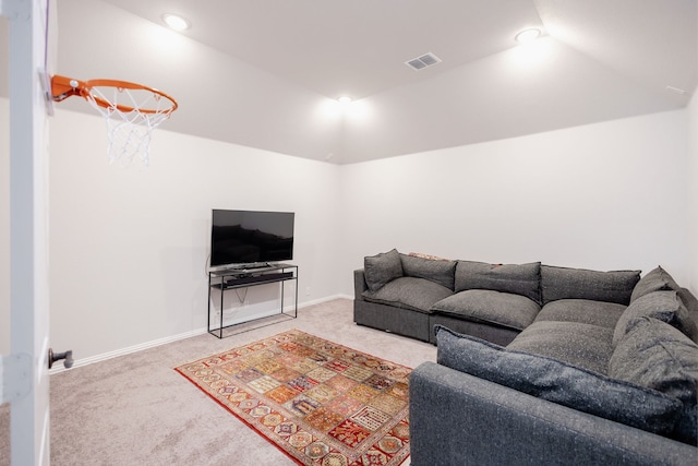 carpeted living room featuring lofted ceiling