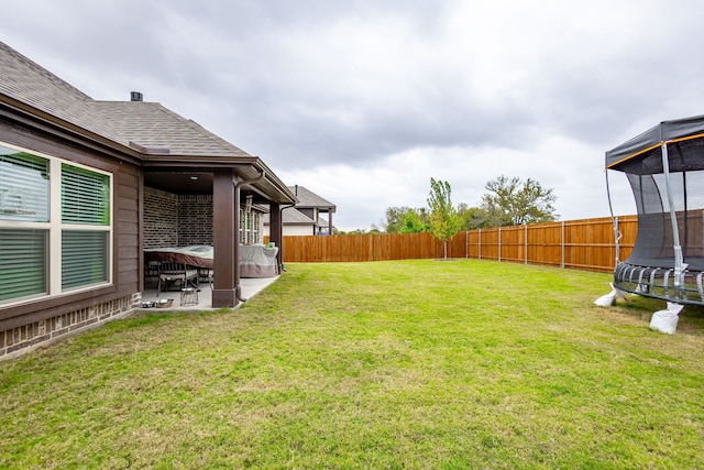 view of yard with a patio area and a trampoline