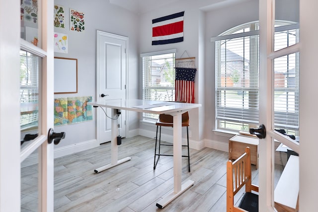 office area featuring light hardwood / wood-style flooring and french doors