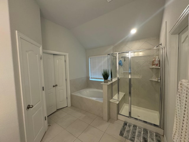 bathroom with tile patterned floors, independent shower and bath, and lofted ceiling