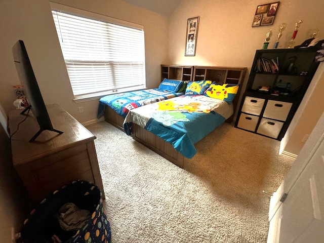 bedroom featuring vaulted ceiling and carpet flooring