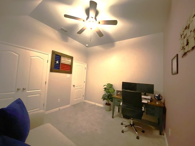 carpeted office with vaulted ceiling and ceiling fan