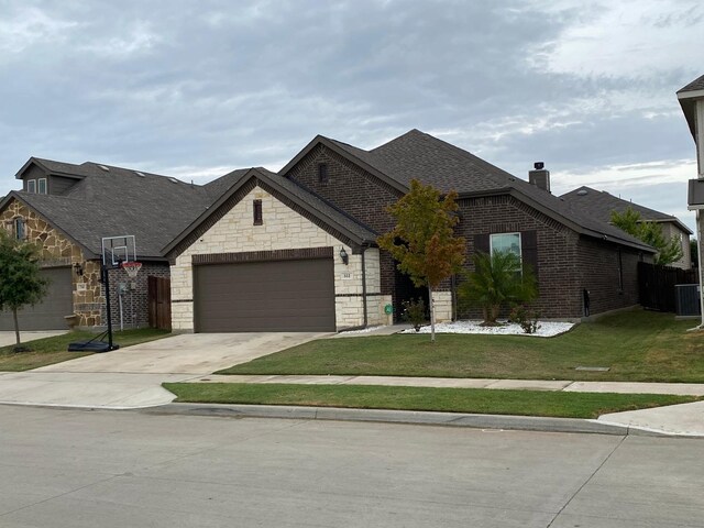 view of front of property featuring a garage and a front lawn