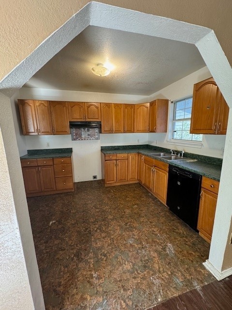 kitchen with dishwasher, dark hardwood / wood-style floors, sink, and a textured ceiling