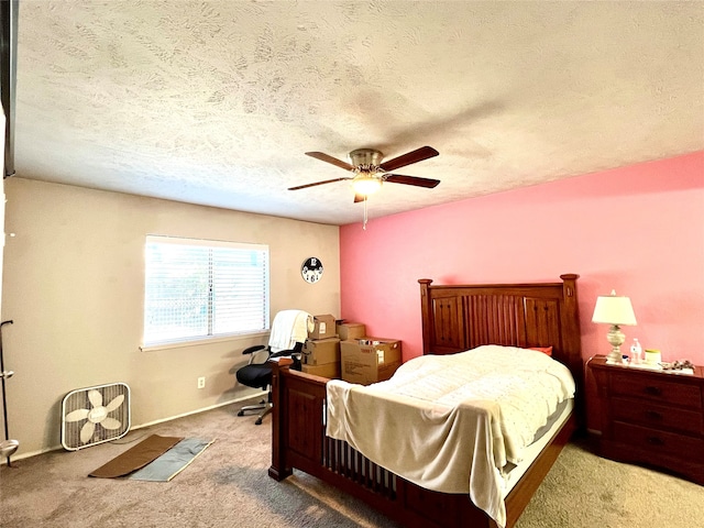 bedroom with carpet flooring, ceiling fan, and a textured ceiling