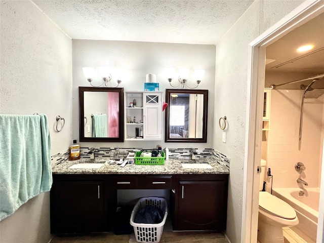 full bathroom with shower / tub combination, vanity, and a textured ceiling