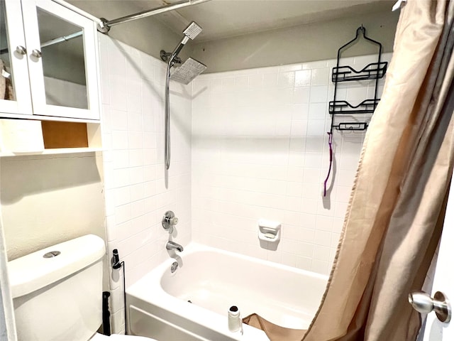 bathroom featuring shower / bathtub combination with curtain and toilet