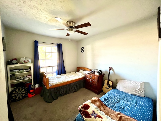 carpeted bedroom with a textured ceiling and ceiling fan