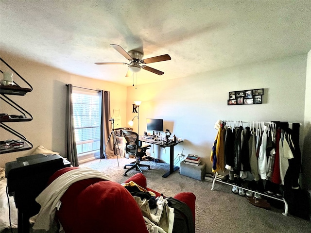 office area featuring carpet flooring, ceiling fan, and a textured ceiling