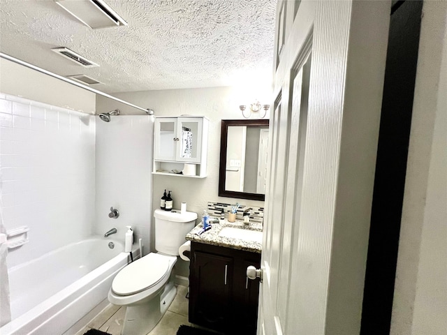 full bathroom with a textured ceiling, vanity, washtub / shower combination, tile patterned flooring, and toilet