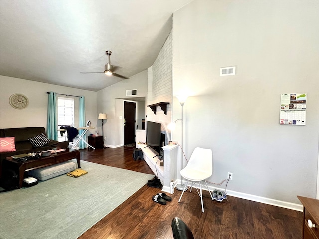 living room featuring ceiling fan, dark wood-type flooring, and vaulted ceiling