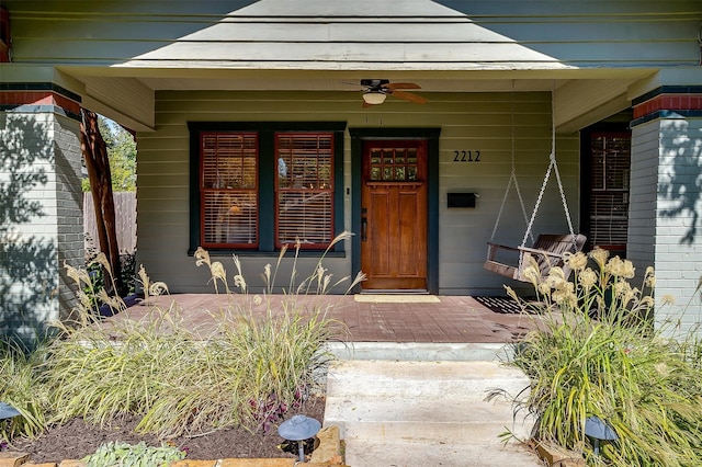 property entrance featuring a porch and ceiling fan