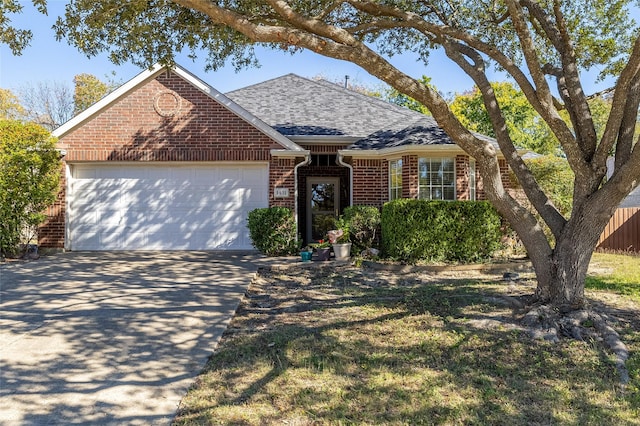 1431 Murphy Dr, Rockwall, TX 75087 - view of front of property featuring brick siding, driveway, an attached garage, and roof with shingles