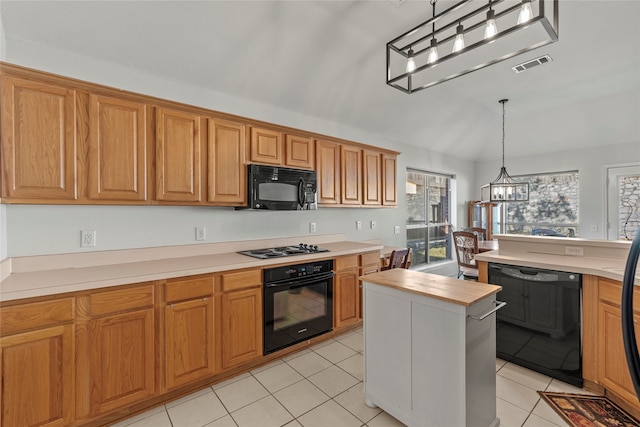 kitchen with black appliances, pendant lighting, a chandelier, a kitchen island, and light tile patterned flooring