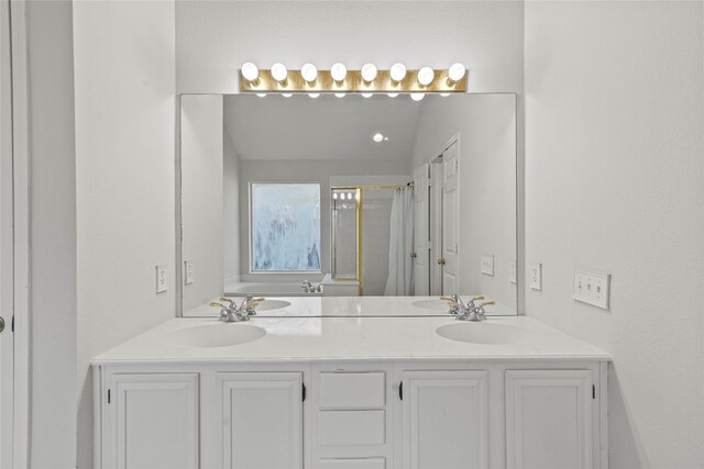 bathroom featuring vanity, walk in shower, and vaulted ceiling