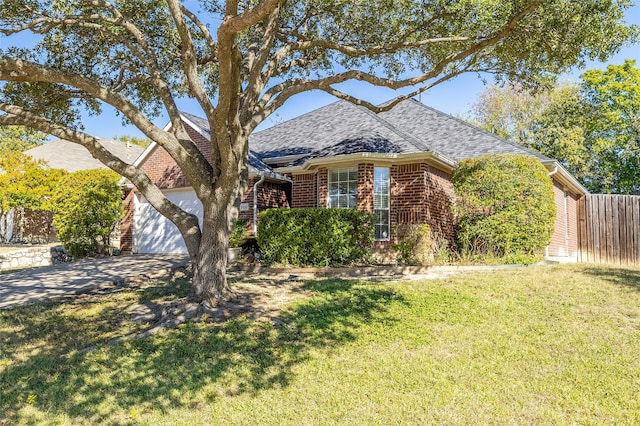 view of front of home with a garage and a front lawn