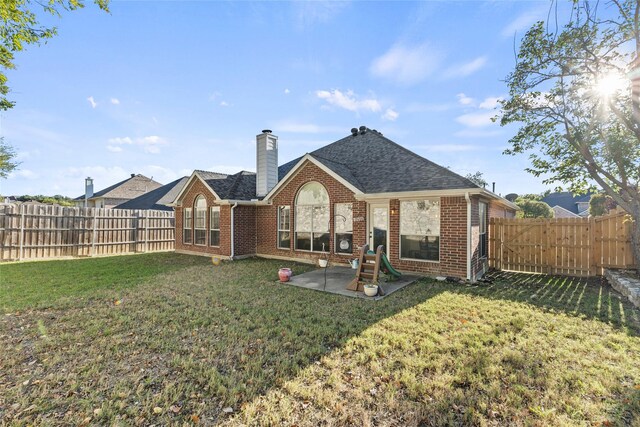 back of house with a lawn and a patio area