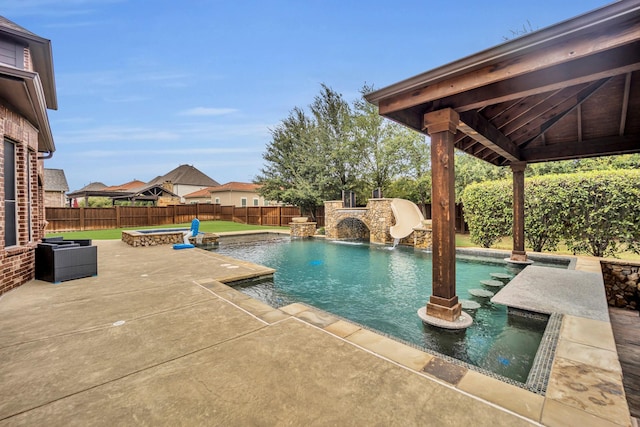 view of swimming pool featuring an in ground hot tub, pool water feature, and a patio area