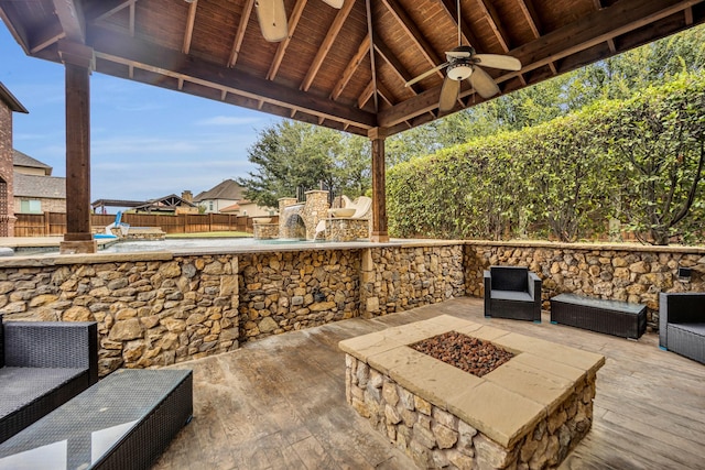 view of patio / terrace with a gazebo, ceiling fan, and an outdoor fire pit