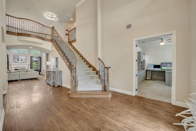 entrance foyer with hardwood / wood-style floors and a high ceiling